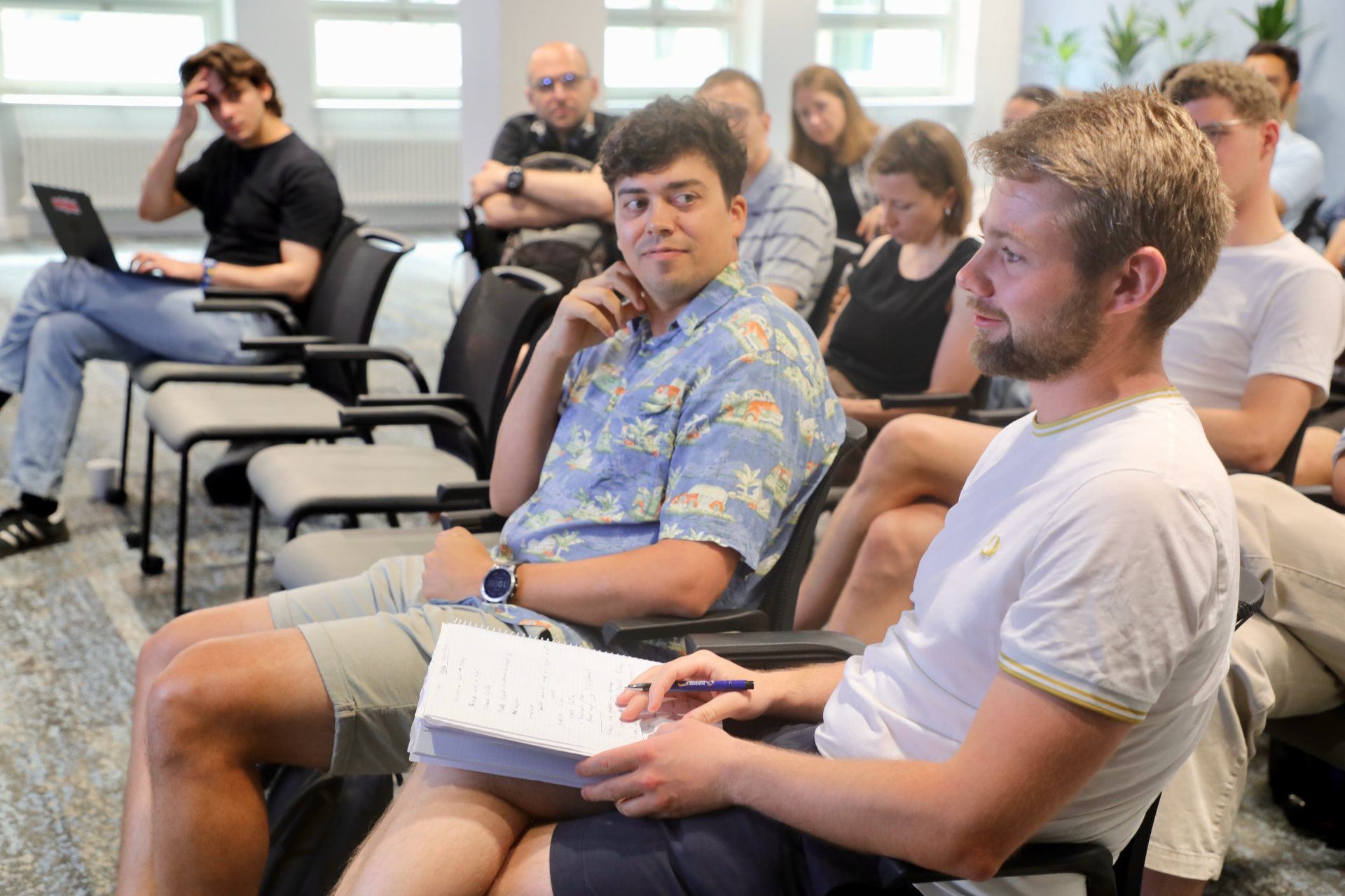 Attendees taking notes during a session